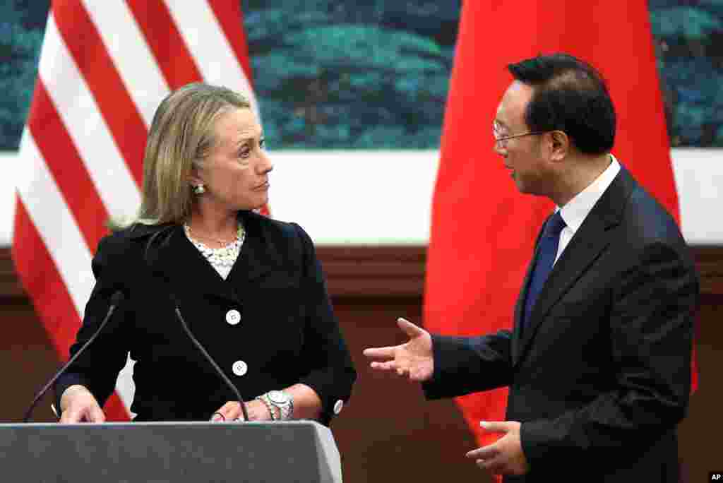 Chinese Foreign Minister Yang Jiechi, right, talks with U.S. Secretary of State Hillary Clinton after attending a press conference at the Great Hall of the People in Beijing, September 5, 2012. 