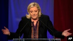 Far right National Front party leader Marine Le Pen delivers a speech after the announcement of partial results in the second round of regional elections, in Henin-Beaumont, northern France, Dec.13, 2015.