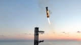 This image provided by SpaceX shows SpaceX's mega rocket booster returning to the launch pad to be captured during a test flight Sunday, Oct. 13, 2024, in Boca Chica, Texas. (SpaceX via AP)