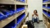 A young woman checks her phone while hiding inside the Sands Corporation plane hangar after a mass shooting in which dozens were killed at the Route 91 Harvest Festival on Oct. 1, 2017, in Las Vegas. 