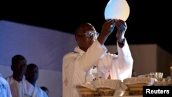 FILE - Archbishop of Bamako, Jean Zerbo, celebrates communion in the town of Kita in western Mali, Nov. 17, 2012.