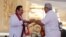 Sri Lanka’s former President Mahinda Rajapaksa, left, receives appointment documents from his younger brother, President Gotabaya Rajapaksa, after being sworn in as the prime minister at Kelaniya Royal Buddhist temple in Colombo, Sri Lanka, Aug. 9, 2020.