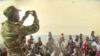 A Cameroonian soldier teaches children at a government school in Fotokol, May 11, 2018. (M. Kindzeka/VOA)