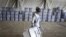 FILE - An Afghan election worker carries ballot boxes at the warehouse of Afghanistan's Independent Election Commission in Kabul, Afghanistan, a few days after parliamentary elections, Sept. 18, 2010.