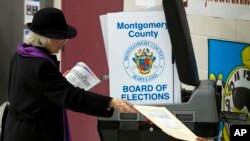 A woman casts her vote at a polling place during the U.S. midterm election Nov. 6, 2018, in Silver Spring, Md.