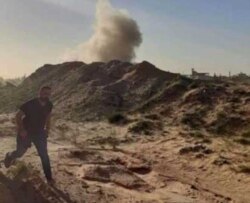 A soldier near Tripoli, Libya, runs as a mortar hits a nearby berm, Dec. 2019 (Courtesy - GNA soldiers)