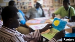 FILE - Patients undergoing a rehabilitation program draw during a therapy session at the Sopi Jikko centre in Dakar, June 6, 2014. Sopi Jikko is a rehabilitation center for people with mental health and drug addiction problems.