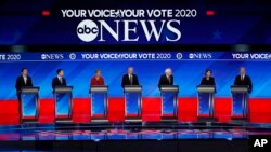 From left, Democratic presidential candidates entrepreneur Andrew Yang, former Mayor Pete Buttigieg, Sen. Bernie Sanders, I-Vt., former Vice President Joe Biden, Sen. Elizabeth Warren, D-Mass., Sen. Amy Klobuchar, D-Minn., and businessman Tom Steyer.