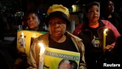 Well-wishers gather in support of ailing former South African President Nelson Mandela outside his former home in Soweto June 27, 2013.
