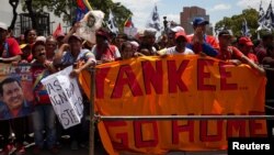 FILE - Supporters of Venezuela's President Nicolas Maduro take part in a rally in support of the government in Caracas, Venezuela, March 16, 2019.