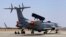 Engineers and support staff sit in the shade of an Embraer EMB-145I aircraft fitted with the India's first indigenous airborne radar system during rehearsals for the Aero India 2015 at Yelahanka air base in Bangalore, India, Feb. 17, 2015.