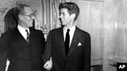 Joseph P. Kennedy, left, U.S. Ambassador to Great Britain, is seen with his son, John F. Kennedy, Jan. 5, 1938, in New York. 