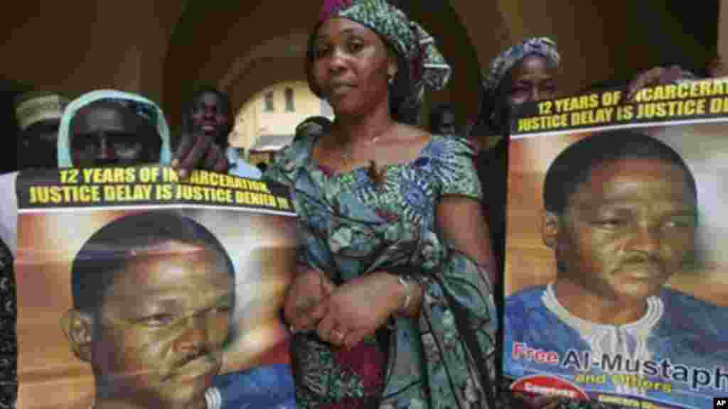 In this 2011 photo, women display a poster of Nigeria&#39;s former Chief security officer, Maj. Hamza Al-Mustapha, at the federal high court in Lagos.