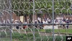 FILE - Inmates are seen in the yard of the Lakeland Correctional Facility, in Coldwater, Michigan, June 1, 2007. 