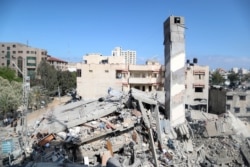 Gedung-gedung yang hancur setelah serangan udara oleh Israel di di tengah konflik bersenjata antara Israel dan Palestina di Kota Gaza, Selasa, 18 Mei 2021.