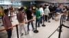 A handout picture released by the Colombian Presidency press office shows migrants deported from the United States lining up at the immigration counter at El Dorado International airport in Bogota, Colombia, Jan. 28, 2025. (Colombia Presidency press office via AFP)
