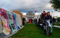 Activists arrive at a camp set for Extinction Rebellion climate activists next to the Reichstag in Berlin, Oct. 5, 2019. Hundreds of activists plan to block major roads in the German capital in a week of protests for new climate-protection policies.