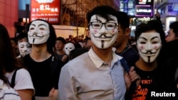 Anti-government protesters wearing costumes march during Halloween in Lan Kwai Fong, Central district, Hong Kong, Oct. 31, 2019.