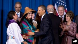 FILE - President Barack Obama greets Our Sisterís Keeper Executive Director Diane Millich, from left, and Tulalip Tribes of Washington State Vice Chairwoman Deborah Parker, after signing the Violence Against Women Act in Washington, D.C., March 7, 2013. Five years after a federal law gave tribes authority over non-Natives for some domestic violence crimes, public safety advocates say communities are empowered to report wrongdoing and governments are working better together.