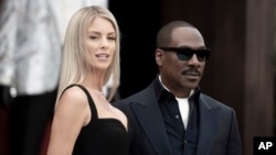 Eddie Murphy, right, and Paige Butcher attend the L.A. premiere of "Dolemite is My Name" at the Regency Village Theatre, Sept. 28, 2019. 