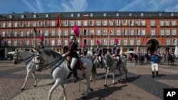 Members of the royal guard wearing face masks to prevent the spread of the coronavirus ride towards the foreign ministry in downtown Madrid, Spain, Sept. 30, 2020. 
