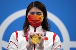 Zhang Yufei of China poses with her gold medal after winning the women's 200-meter butterfly final at the 2020 Summer Olympics, July 29, 2021, in Tokyo, Japan.