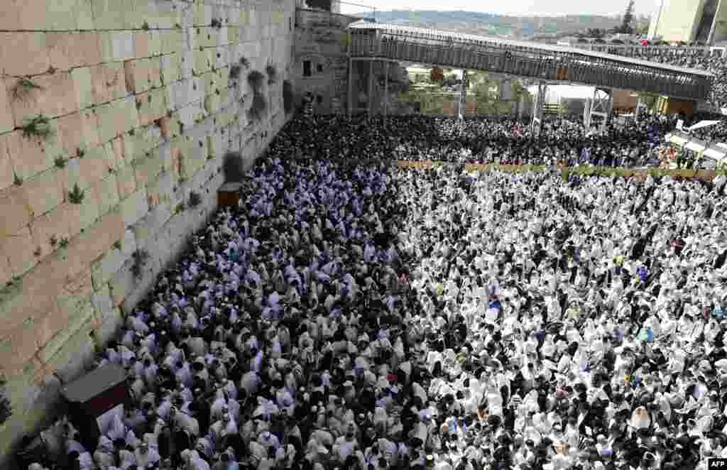 Jewish priests wearing "Talit" (prayer shawls) and civilians take part in the Cohanim prayer (priest's blessing) during the Passover (Pesach) holiday at the Western Wall in the Old City of Jerusalem.