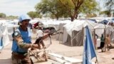 FILE - A United Nations peacekeeper keeps guard outside the Bor camp for the internally displaced in Bor town Jonglei state, South Sudan, Apr. 29, 2014. 