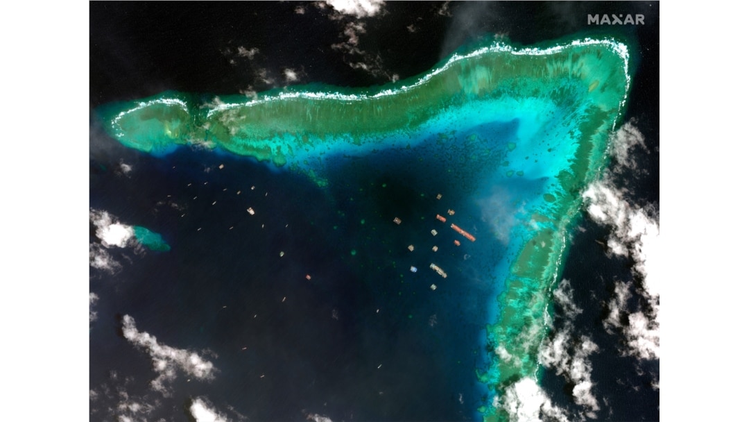 FILE - This satellite image provided by Maxar Technologies shows Chinese vessels at the Whitsun reef, in a disputed part of the South China Sea, March 23, 2021.
