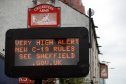 An information on COVID-19 sign is seen during stricter restrictions due to the coronavirus disease outbreak in Sheffield, Britain, Oct. 21, 2020. (Reuters)