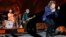 Mick Jagger, right, performs with Keith Richards, center, and Charlie Watts on drums as The Rolling Stones play in their "Zip Code" tour in Pittsburgh, June 20, 2015.
