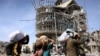 Displaced Palestinians carry their belongings as they walk amid the devastation upon their return to central Rafah in the southern Gaza Strip on Jan. 19, 2025, after a ceasefire between Israel and the Hamas movement took effect.