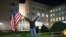 Marianne Hoenow from the U.S. state of Connecticut celebrates the victory of President-elect Joe Biden and Vice President-elect Kamala Harris in front of the U.S. Embassy next to the Brandenburg Gate in Berlin, Germany, Nov. 7, 2020. 