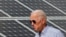 FILE - Joe Biden, then U.S. vice president, walks past solar panels while touring the Plymouth Area Renewable Energy Initiative in Plymouth, New Hampshire, June 4, 2019. As president, Biden will use executive action on Monday to help bridge a solar panel supply gap.
