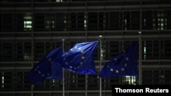 European Union flags flutter outside the European Commission headquarters during an EU leaders summit at the European Council headquarters, in Brussels, Belgium, Dec. 10, 2020.