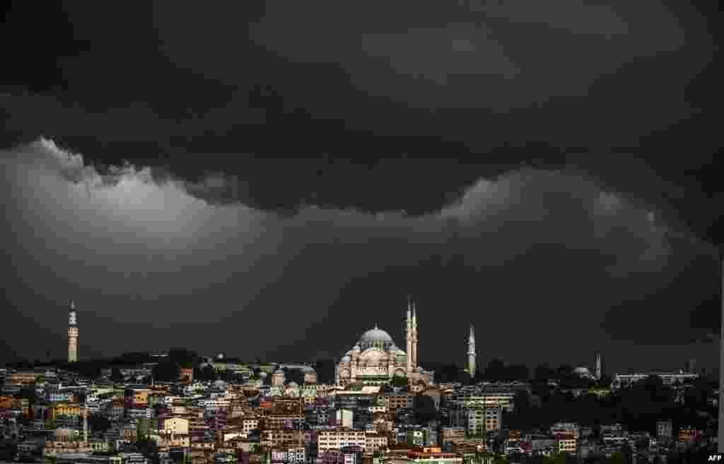 Clouds gather over the Suleymaniye Mosque during a storm in Istanbul, Turkey.
