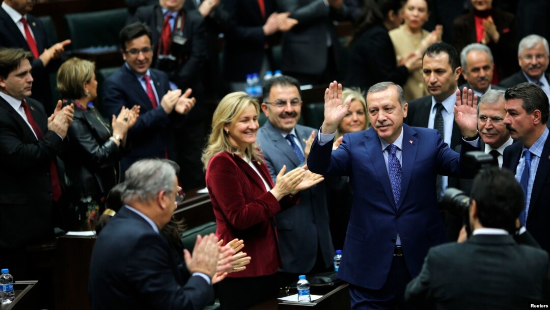 Turkey's Prime Minister Tayyip Erdogan greets his supporters as he arrives at a meeting at the Turkish parliament in Ankara, Feb. 18, 2014. 