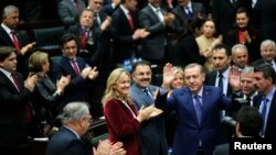FILE - Turkey's Prime Minister Tayyip Erdogan greets his supporters in parliament. 