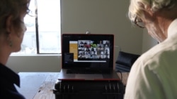 FILE - University of California professors Lisa Wymore and Greg Niemeyer look at the Zoom screen showing students in their online Collaborative Innovation course in Berkeley, March 12, 2020.