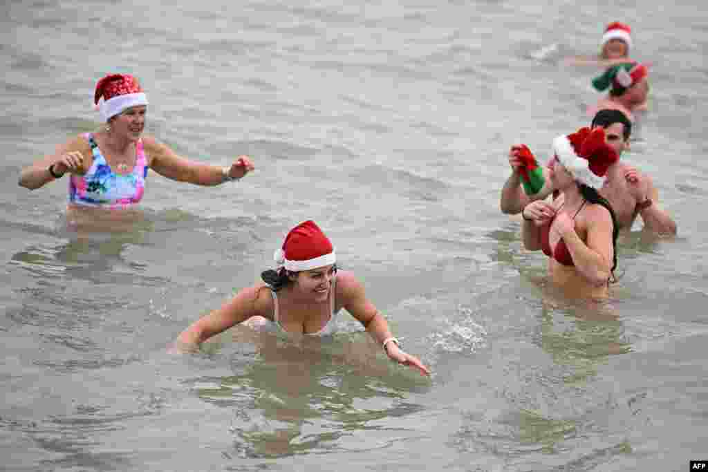 Participants take part in a Christmas day swim in the sea at Brighton beach, southern England, Dec. 25, 2024.