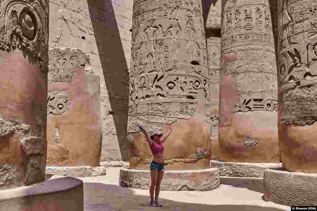 On World Heritage Day a tourist poses for a photograph in Karnak temple in Luxor, Egypt, April 20, 2018.