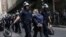 Police officers take away a protester during an Occupy Wall Street march at the New York Stock Exchange in Manhattan, Sept. 17, 2012.