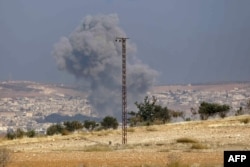 Smoke billows in the the Syrian town of Suran, between Aleppo and Hama, Dec. 3, 2024.