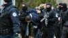 Kosovo police escort Marko Djuric a Serb official to a police station in Kosovo capital Pristina after he was arrested in northern Kosovo town of Mitrovica, Monday, March 26, 2018. 
