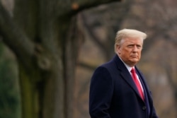 FILE - President Donald Trump walks on the South Lawn of the White House in Washington before boarding Marine One, Dec. 12, 2020.