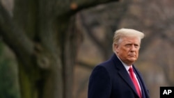 President Donald Trump walks on the South Lawn of the White House in Washington before boarding Marine One, Dec. 12, 2020.