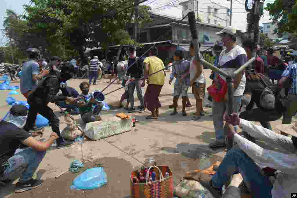 Anti-coup protesters use oversized slingshot to confront police in Yangon, Myanmar.&nbsp;Protesters returned to the streets to press their demands for a return to democracy, just a day after security forces killed more than 100 people in the bloodiest day since last month&#39;s military coup.