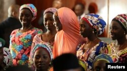 FILE - Some of the 21 Chibok girls released by Boko Haram look on during their visit to meet President Muhammadu Buhari In Abuja, Nigeria, Oct. 19, 2016.