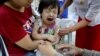 FILE - A child reacts after receiving a measles-rubella vaccination in Yangon, Myanmar, Nov. 26, 2019. 