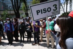 People take part in an earthquake drill, the first since the beginning of the COVID-19 pandemic, in Mexico City on June 21, 2021.